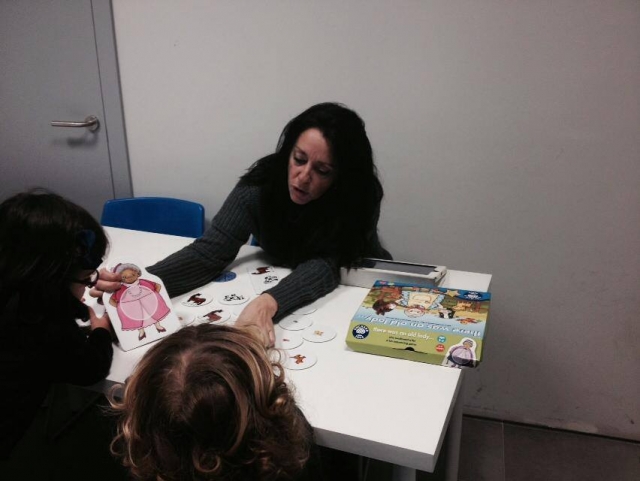  teacher showing a drawing to two girls